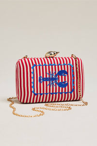 The selected item is the Shiraleah Marina Red Striped Lobster Minaudière Clutch.This nautical-inspired evening bag features a structured box silhouette dressed in bold red and white vertical stripes. It is accented by a prominent, bright blue embroidered