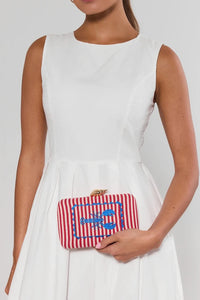 The selected item is the Shiraleah Marina Red Striped Lobster Minaudière Clutch.This nautical-inspired evening bag features a structured box silhouette dressed in bold red and white vertical stripes. It is accented by a prominent, bright blue embroidered